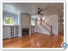 This open-spaced concept family living space is large but warm and inviting.  Notice the attention to detail:  fireplace with elaborate cabinetry (including German-cut glass) and the traditional, Victorian stairway.