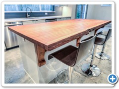 Close up of solid brazilian cherry slab island countertop.  Countertop is 7’ long.