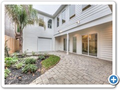 Garage door provides extra indoor party space.  2nd floor windows show courtyard view from crown-jewel master suite and catwalk.